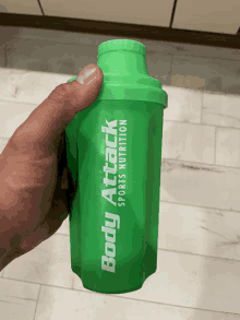 a green shaker that says body attack sports nutrition on it