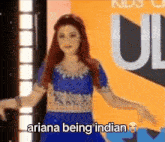 ariana grande is wearing a blue dress and dancing