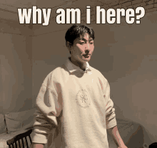 a man wearing a sweater that says " why am i here "