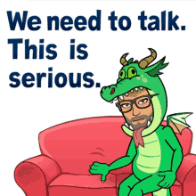 a man in a dragon costume is sitting on a couch with the words we need to talk