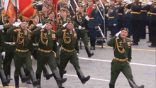 a group of soldiers marching in a parade with one of them wearing a badge with the letter g on it