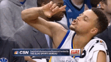 a basketball player is making a funny face while sitting in the stands during a game sponsored by the elias sports bureau