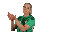 a woman wearing a green shirt with the word ireland on it