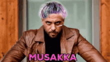 a man with purple hair is wearing a brown leather jacket with musakka written on it