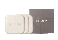 a box of natura homem soap sits next to two bars of soap