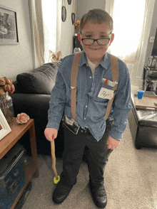 a young boy in a costume has a name tag that says pops