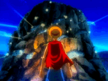 a man in a red cape stands in front of a large rock formation