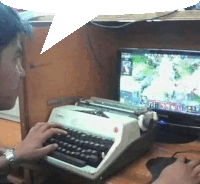 a man is typing on a typewriter next to a computer monitor