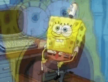 a cartoon of spongebob sitting in front of a computer