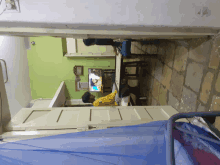 a man sits at a desk in front of a television