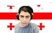 a man wearing headphones in front of a flag