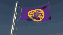 a purple and yellow flag with a picture of a man in the middle