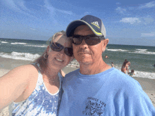 a man wearing a blue shirt that says assault life poses with a woman