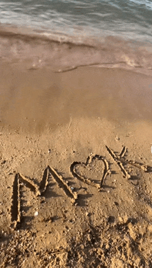 the letters m and y are written in the sand