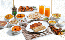 a table topped with a variety of indian food and drinks