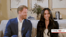 a man and a woman are sitting on a couch and the woman is wearing a white top that says time 100