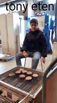 a man is sitting in a chair cooking hamburgers on a grill with the words tony eten above him .