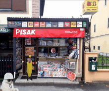 a tobacco store with a red sign that says ' pisak '