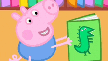 peppa pig is holding a green book with a dinosaur on it