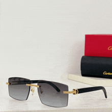 a pair of cartier sunglasses sits on a shelf