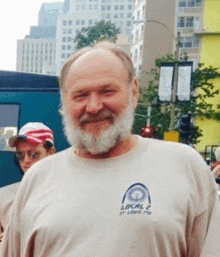 a man with a beard wearing a local 2 shirt