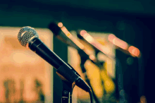 a row of microphones are lined up in a row with a blurred background