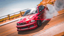 a red bmw is drifting on a road