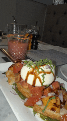 a plate of food with tomatoes and mozzarella on it