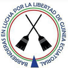 a logo with two crossed brooms in a circle and a triangle in the middle .