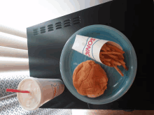 a sonic hamburger and fries on a blue plate