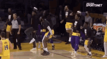 a group of basketball players are dancing on a basketball court .