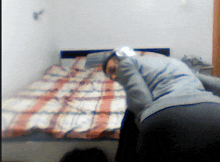 a blurry picture of a person kneeling on a bed