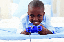 a young boy is playing a video game with a blue controller