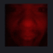 a blurry picture of a person 's face in a dark room .