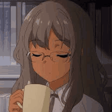 a girl with glasses is holding a cup of coffee in her hand .