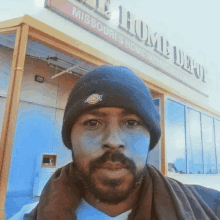 a man standing in front of a missouri 's home depot sign