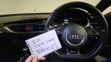 a person holding a note that says " in this chat brokies "