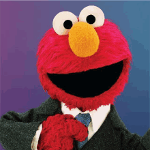 elmo from sesame street is wearing a suit and tie .