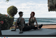 a man and a woman are sitting on a bed looking out at the ocean