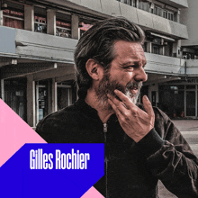 a man with a beard and the name gilles rochier on the corner