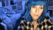 a girl with blue hair is wearing headphones