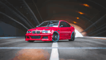 a red bmw is parked in a tunnel