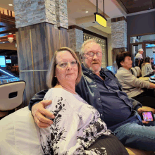 a man and a woman are posing for a photo in a casino