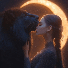 a woman is kissing a black lion in front of a full moon