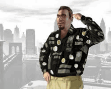 a man wearing a black shirt with white polka dots is standing in front of a city skyline .