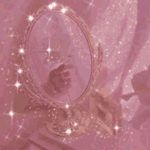 a woman is holding a flower in front of a mirror on a pink background