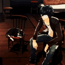 a man sits in a chair with a cat on a chair next to him