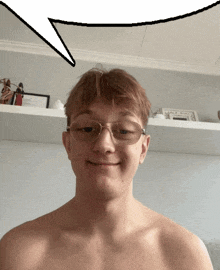 a shirtless young man wearing glasses is smiling with a speech bubble above his head