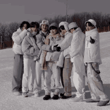 a group of people are posing for a picture in the snow with one wearing a hat that says " i love you "