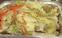 a tray of food with lettuce olives and cheese